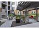 Outdoor courtyard with pergola, fireplace and dining area, with manicured plantings at 901 Abernathy Rd # 2200, Sandy Springs, GA 30328