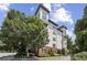 Inviting four-story condo building featuring brick accents, multiple balconies, and lush landscaping at 901 Abernathy Rd # 2200, Sandy Springs, GA 30328