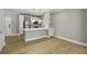 Open-concept living space with a modern kitchen, stainless steel appliances, and hardwood floors at 901 Abernathy Rd # 2200, Sandy Springs, GA 30328