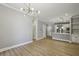 Bright living area featuring hardwood floors, recessed lighting, and an open layout to the kitchen at 901 Abernathy Rd # 2200, Sandy Springs, GA 30328