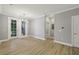 Light-filled living area with hardwood floors and access to a balcony through double doors at 901 Abernathy Rd # 2200, Sandy Springs, GA 30328