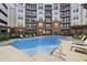 Resort-style pool surrounded by lounge chairs and lush landscaping at 901 Abernathy Rd # 2200, Sandy Springs, GA 30328