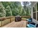 Relaxing outdoor space with a wooden deck, grill, and seating surrounded by lush greenery and providing privacy at 1823 Lynwood Ln, Atlanta, GA 30329