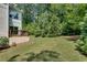 A lush, manicured backyard features a small deck, green lawn, and mature trees offering shade and privacy at 1823 Lynwood Ln, Atlanta, GA 30329