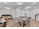 The basement game room has a ping pong table, a foosball table, exercise equipment, and hardwood flooring at 1823 Lynwood Ln, Atlanta, GA 30329