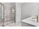 The bathroom has a glass shower door, a double sink, white quartz countertops, and tile flooring at 1823 Lynwood Ln, Atlanta, GA 30329