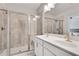 Modern bathroom features double sinks, white cabinets, tile floors, and a glass enclosed shower with a bench at 1823 Lynwood Ln, Atlanta, GA 30329