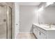 The bathroom has a glass shower door, a double sink, a white cabinet and tile flooring at 1823 Lynwood Ln, Atlanta, GA 30329