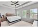 Bright bedroom features a modern bed with a wooden headboard and three windows allowing ample natural light at 1823 Lynwood Ln, Atlanta, GA 30329