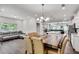 Bright dining area with large wooden table, modern chandelier, access to living and kitchen areas at 1823 Lynwood Ln, Atlanta, GA 30329