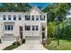 Inviting townhome with brick facade, attached garage, and meticulously maintained landscaping at 1823 Lynwood Ln, Atlanta, GA 30329