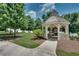 Picturesque gazebo with stone fireplace nestled among mature trees and landscaping, offering an inviting outdoor space at 1823 Lynwood Ln, Atlanta, GA 30329