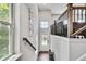 This is a stairway hallway that leads to a front door with sidelights and dark hardwood flooring at 1823 Lynwood Ln, Atlanta, GA 30329