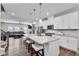 Modern eat-in kitchen featuring white cabinets, granite counters, stainless steel appliances, and open view to the living room at 1823 Lynwood Ln, Atlanta, GA 30329