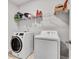 Modern laundry room with a large washer and dryer, wire shelving, and tiled floor at 1823 Lynwood Ln, Atlanta, GA 30329
