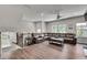 Bright living room featuring hardwood floors, a large sectional sofa, and ample natural light at 1823 Lynwood Ln, Atlanta, GA 30329