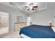 Bright main bedroom features a king bed, dresser, and a glimpse into the en-suite bathroom at 1823 Lynwood Ln, Atlanta, GA 30329