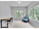 Well-lit office area with desk and modern chair, and a view to the outside at 1823 Lynwood Ln, Atlanta, GA 30329