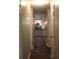 Hallway with wood flooring leading to a kitchen with stainless steel appliances and pendant lighting at 3501 Shepherds Path, Decatur, GA 30034