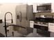 The modern kitchen is equipped with stainless steel appliances and a black countertop at 3501 Shepherds Path, Decatur, GA 30034