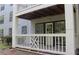 Outdoor patio with white railings, exterior access, and partial view of the building's siding at 3501 Shepherds Path, Decatur, GA 30034