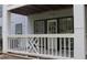 Outdoor patio with white railings, exterior access, and partial view of the building's siding at 3501 Shepherds Path, Decatur, GA 30034