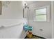 Bathroom with a blue sink, white tile walls, and patterned floor tiles at 1544 Brewer Sw Blvd, Atlanta, GA 30310