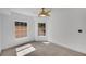 Bright bedroom featuring two windows and a unique ceiling fan at 230 E Ponce De Leon Ave # 116, Decatur, GA 30030