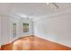 Bright bedroom with hardwood floors, ceiling fan, and access to a balcony at 230 E Ponce De Leon Ave # 116, Decatur, GA 30030