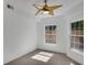 Bright bedroom featuring two windows and a unique ceiling fan at 230 E Ponce De Leon Ave # 116, Decatur, GA 30030