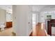Bright condo entryway with hardwood floors leading to the bathroom, kitchen and living area at 230 E Ponce De Leon Ave # 116, Decatur, GA 30030
