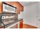 Close up view of stainless steel appliances and wood cabinets in the kitchen at 230 E Ponce De Leon Ave # 116, Decatur, GA 30030