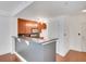 Kitchen area with stainless steel appliances, wood cabinets, and bar seating at 230 E Ponce De Leon Ave # 116, Decatur, GA 30030