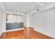 View of the living room and kitchen area with hardwood floors and bright, white walls at 230 E Ponce De Leon Ave # 116, Decatur, GA 30030