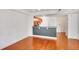 Open-concept living room with hardwood floors, gray accent wall, and access to the kitchen at 230 E Ponce De Leon Ave # 116, Decatur, GA 30030