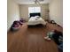 Bright bedroom with a window, hardwood floors, and a simple bed setup at 2390 Coach Way, Jonesboro, GA 30236