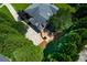 Aerial shot of a backyard showcasing a stone patio, well-manicured lawn, and mature trees, providing a serene outdoor space at 360 Hannaford Dr, Roswell, GA 30075