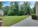 Backyard view with a grassy lawn, a concrete patio, a playset and a fenced perimeter at 360 Hannaford Dr, Roswell, GA 30075