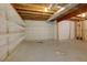 Unfinished basement with exposed wooden beams, ductwork, concrete floor and shelving at 360 Hannaford Dr, Roswell, GA 30075