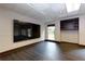 Finished basement includes vinyl floors, built-in shelving, and a wall-mounted TV at 360 Hannaford Dr, Roswell, GA 30075