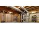 Unfinished basement featuring exposed ductwork, lumber and a concrete floor at 360 Hannaford Dr, Roswell, GA 30075