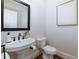 Powder room features a pedestal sink, stylish mirror, and white paint at 360 Hannaford Dr, Roswell, GA 30075