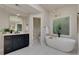 Bright bathroom with marble floors, soaking tub, glass shower, and vanity with drawers and gold hardware at 360 Hannaford Dr, Roswell, GA 30075