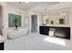 Bright bathroom features marble floors, a soaking tub, glass shower, and dual vanities with a makeup table at 360 Hannaford Dr, Roswell, GA 30075