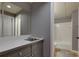 Finished basement bathroom featuring a tub and a gray vanity with a stainless-steel sink at 360 Hannaford Dr, Roswell, GA 30075