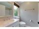 Bright bathroom with a window, pink marble sink, and a shower with a white tile surround at 360 Hannaford Dr, Roswell, GA 30075