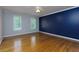 Empty bedroom with wood floors, neutral walls, white trim, and two windows at 360 Hannaford Dr, Roswell, GA 30075