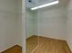 Walk-in closet with mirror and wood floor features wire racks for ample storage space at 360 Hannaford Dr, Roswell, GA 30075