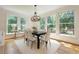 Dining area with hardwood floors and large windows overlooking a green view at 360 Hannaford Dr, Roswell, GA 30075
