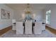 Formal dining room with hardwood floors, chandelier, and white wainscoting at 360 Hannaford Dr, Roswell, GA 30075